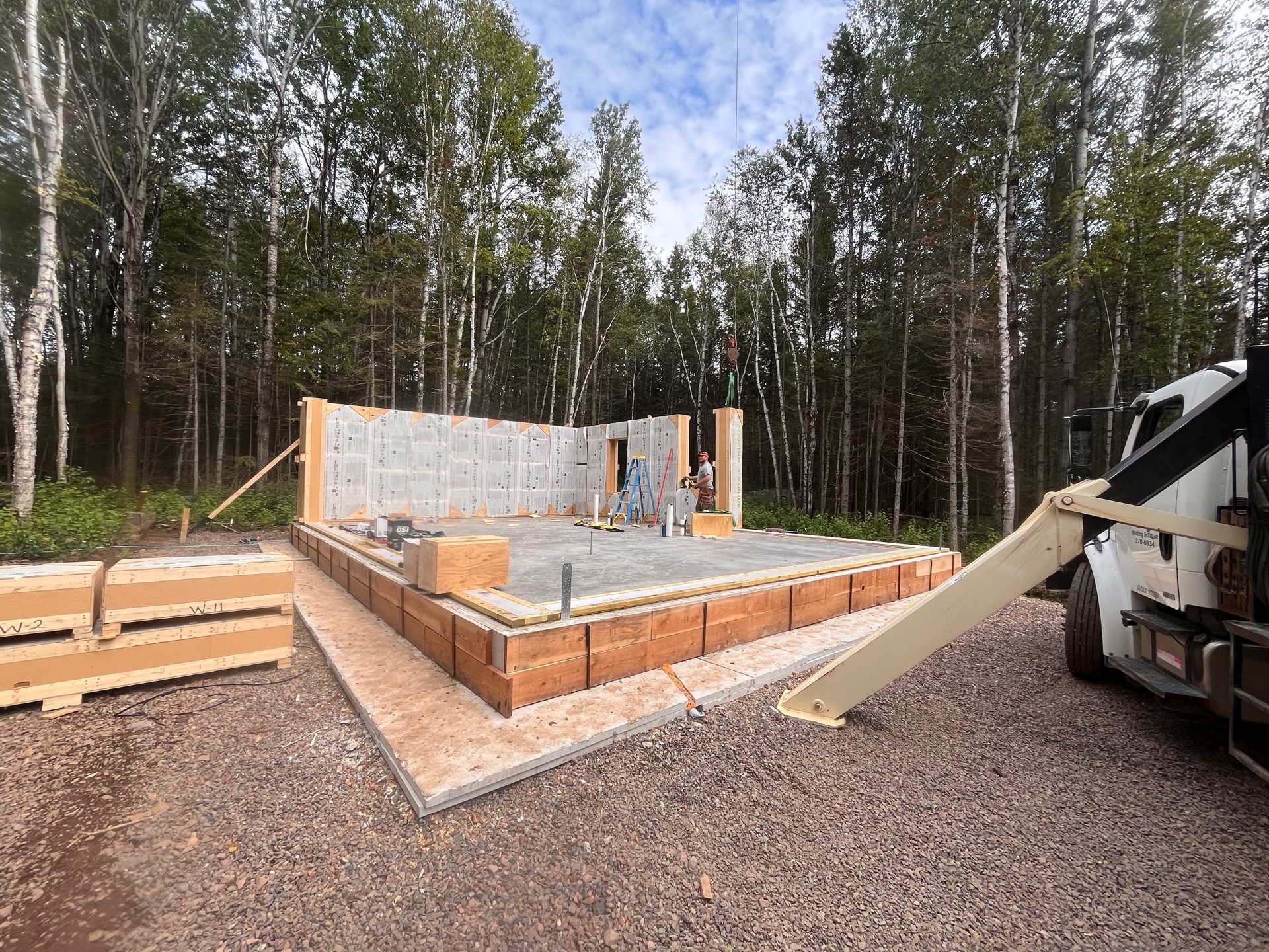 Builders securing a strawbale panel corner joint